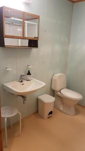 a bathroom with a toilet and a sink at Leite Telt Camping in Lyngstad