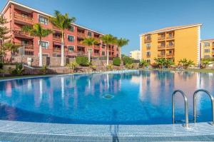 a large swimming pool in front of some apartment buildings at Mocan Perfect Stay in Palm-Mar