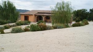 a house in the middle of a dirt field at Case Vacanza La Dolce Vita in Saturnia
