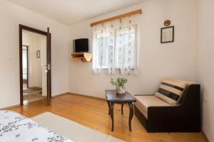 a bedroom with a couch and a table and a chair at Villa Samodiva in Yagodina