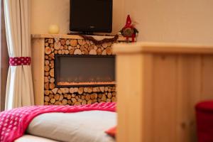 a bedroom with a bed and a tv at Hotel Krone in Livigno