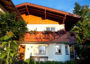 ein Haus mit einem Balkon mit Blumen darauf in der Unterkunft Ferienhaus Deutschmann in St. Johann im Pongau