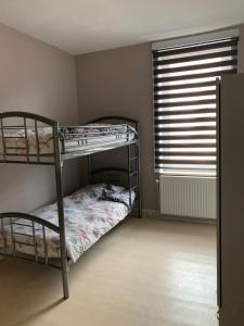 a bedroom with two bunk beds and a window at Zenitude in Jumet