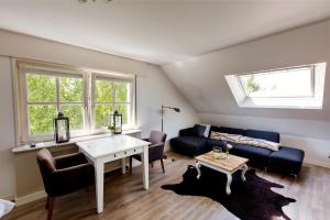 a living room with a couch and a table at B&B Wijk aan Duin in Beverwijk
