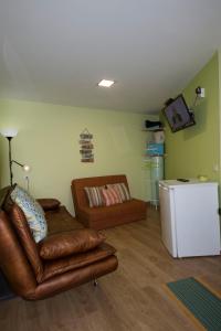 a living room with a couch and a white refrigerator at Moinho do Prado in Vila Nova de Cerveira