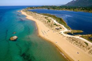 an aerial view of a beach and the ocean at Issos Studios in Agios Georgios