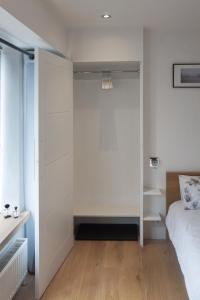 a bedroom with a bed and a closet at Orchard Road Studio Apartment in Hook Norton