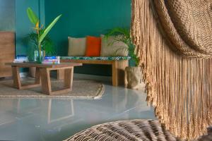 a living room with a couch and a table at Albatros Suites by Bedsfriends in Cozumel