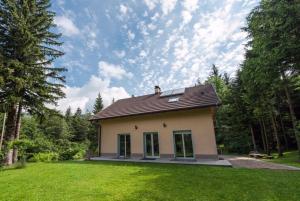 a small house in the middle of a yard at Apartmaji Velikonja in Ajdovščina