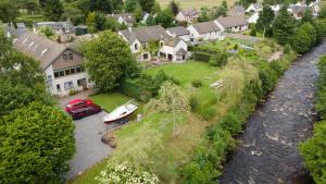 an aerial view of a house with a boat in a yard at Loch Ness Balcony Apartment in Drumnadrochit
