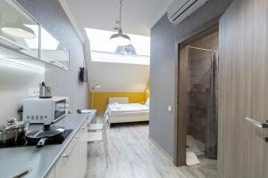 a bathroom with a sink and a shower in a room at Opera Passage Hotel & Apartments in Lviv