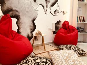 a room with two red chairs and a map on the wall at LA 88 Boutique in St Paul's Bay +29 photos