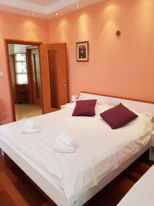 a hotel room with a bed and a dresser at Apartment Karmen in Dubrovnik
