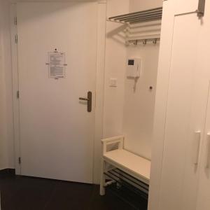 a white door with a bench in a room at Apartmen -Studio in Prague