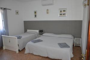 a room with three beds and a laptop in it at Monte O Alentejo in Ourique