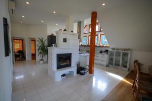 a living room with a fireplace in a kitchen at Villa Katarina in Mokronog
