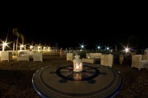 a table with a light on top of it at night at Yachting Club Mare in Patti +69 photos