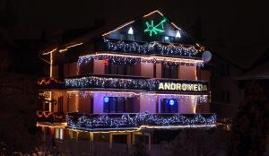 a building decorated with christmas lights and a star at Willa Andromeda in Karpacz