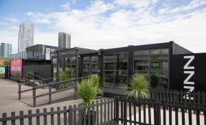 a building with a zebra sign on the side of it at Snoozebox Olympic Park in London