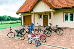a group of bikes parked in front of a house at IKA in Biskupiec