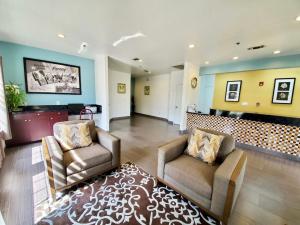 a lobby with two chairs and a waiting room at Super 8 by Wyndham Forney/East Dallas in Forney