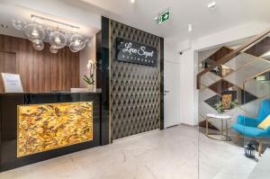 a store lobby with a large fireplace and a blue chair at Love Sopot Residence in Sopot