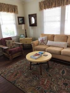 a living room with a couch and a coffee table at Coronado Palms Coastal Cottage in Galveston