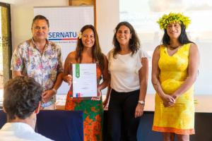 a group of people holding up a certificate at Cabañas Tokerau in Hanga Roa