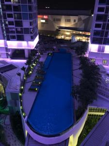 an empty swimming pool in a building at night at Sun-Suite in Shah Alam