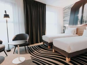 Cama ou camas em um quarto em Novotel Angers Centre Gare