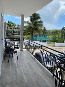 a balcony with chairs and a view of the water at Walk to the Beach 2Min, Cozy, Boutique, Pool, Palmeras Del Mar Isabela in Isabela