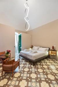 a bedroom with a large bed and a table at Dimora Clementina in Putignano