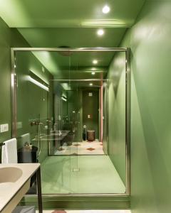 a bathroom with a glass shower and a sink at Dimora Clementina in Putignano