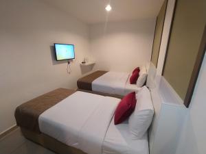 מיטה או מיטות בחדר ב-Crescendo Boutique Hotel