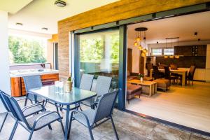 a dining room and living room with a table and chairs at Penthouse apartments in Trstená