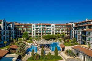 an apartment complex with a pool and a resort at Rose Gardens Apart Hotel in Pomorie