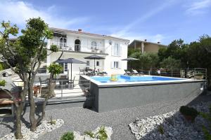 a house with a swimming pool in front of it at My Day House App1 in Klenovica