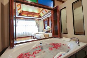 a bathroom with a sink and a mirror at Pingviman Hotel in Chiang Mai