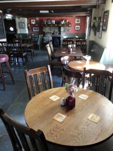 a dining room with wooden tables and chairs at the Engine Inn in Penzance