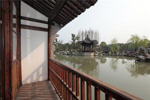 a building with a view of a river and a pagoda at Dockside Boutique Hotel (In Xizha Scenic Area - ticket included) in Tongxiang