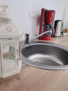 a kitchen counter with a sink and a coffee maker at Casa Bella in Sibiu +46 photos