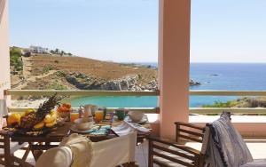 a dining room with a table with a view of the ocean at Angeliki Private Panorama House, by Elefthia Syros in Megas Gialos - Nites