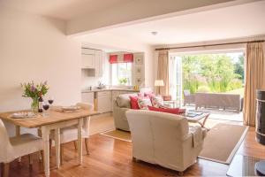 a kitchen and living room with a table and chairs at The Lily Pad in Thorpeness