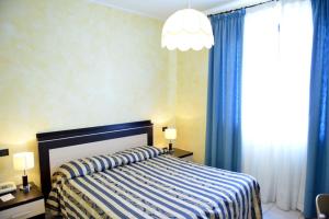 Postel nebo postele na pokoji v ubytování Hotel Blue Rose's