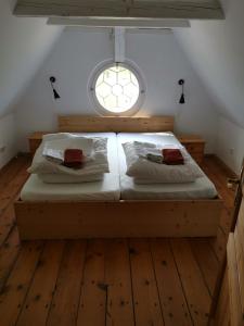 a bedroom with a large bed with a window at Gutshaus Thorstorf FeWo Poel in Thorstorf
