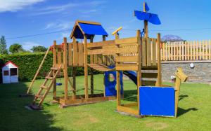 a wooden playground with a ladder and a slide at Cabanas de Vendaval in Malpica