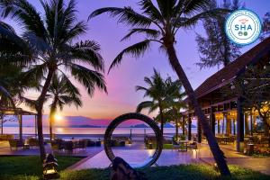 a view of a resort with a pool and palm trees at Amari Vogue Krabi in Tab Kaek Beach
