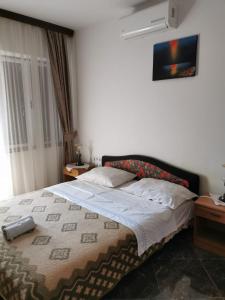 a bedroom with a large bed with a blanket at Apartment Dalmatini in Vabriga