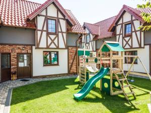 a house with a playground in front of it at Kaszubskie Zacisze in Władysławowo