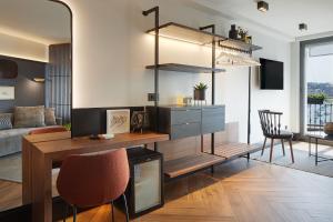 a living room with a table and chairs and a couch at Hotel SANSEbay in Donostia-San Sebastián